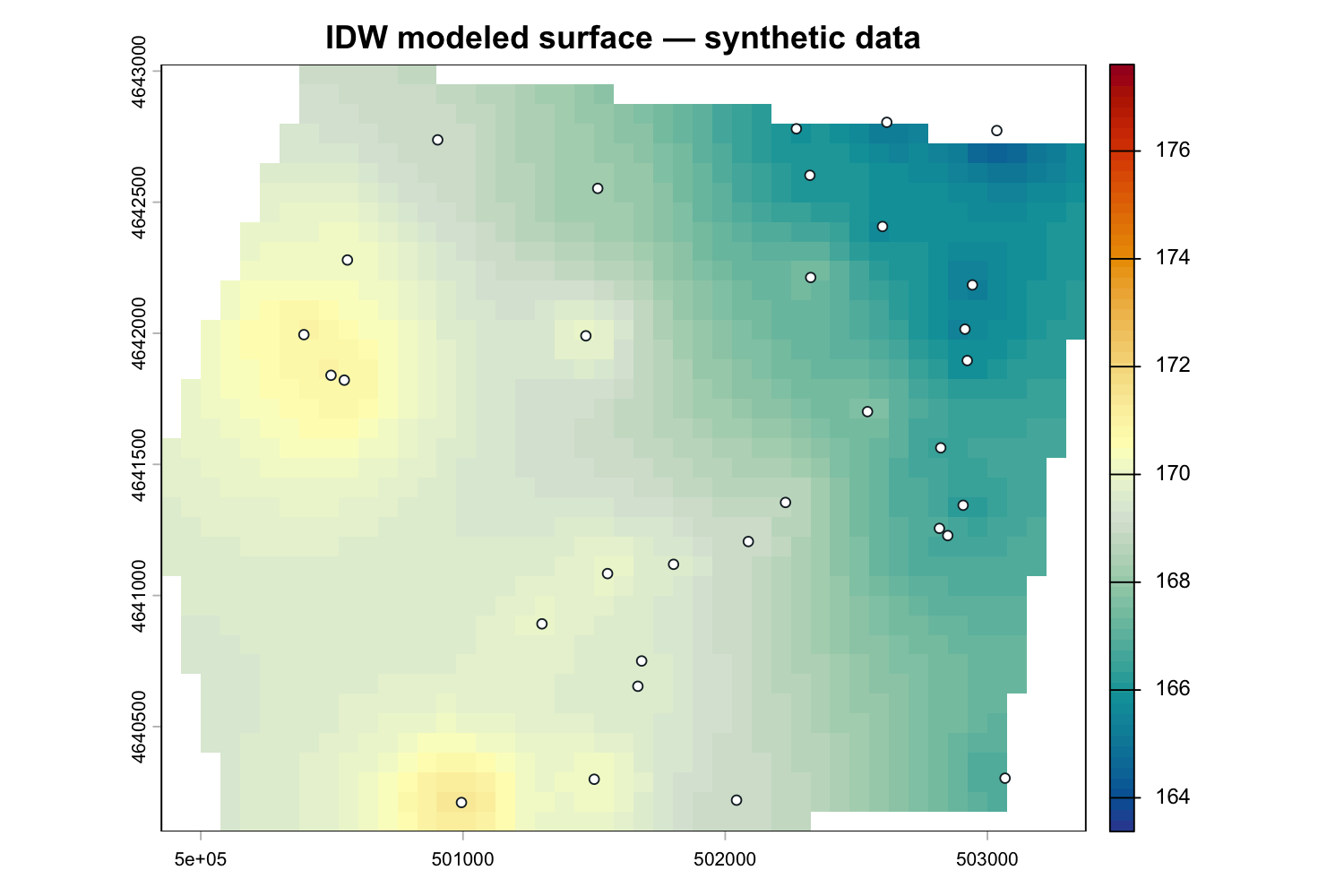 Inverse-distance-weighted surface shaded blue at lower synthetic heads and red at higher heads, with monitoring wells.